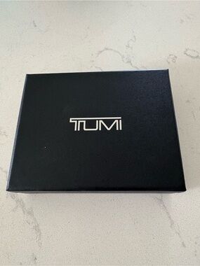 Tumi Black Box with Silver Logo Center and Dust Cover